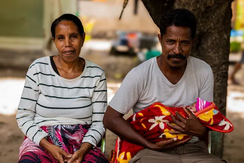 Mother, Father, and their baby in health facility 01-Post small